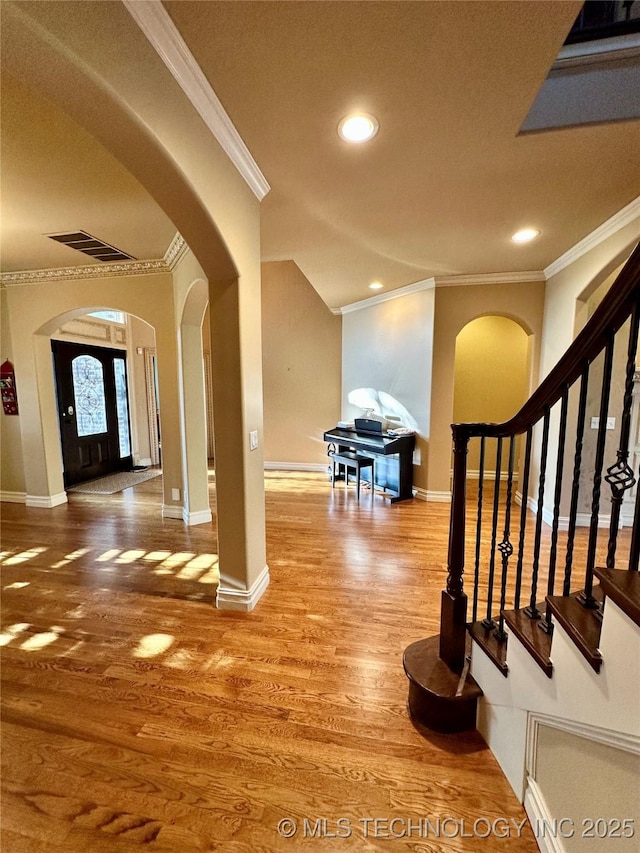 10213 S 88th E Ave, Tulsa, OK 74133 - entryway featuring crown molding, arched walkways, recessed lighting, wood finished floors, and stairs