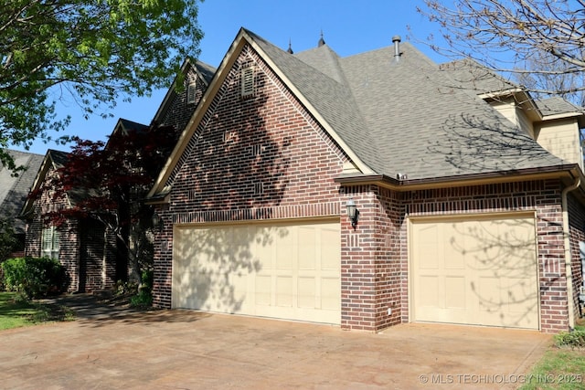 10213 S 88th E Ave, Tulsa, OK 74133 - view of home's exterior featuring brick siding, a shingled roof, driveway, and an attached garage