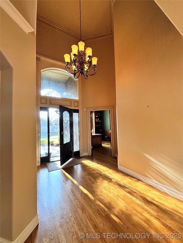 10213 S 88th E Ave, Tulsa, OK 74133 - foyer entrance with a chandelier, ornamental molding, wood finished floors, a towering ceiling, and arched walkways