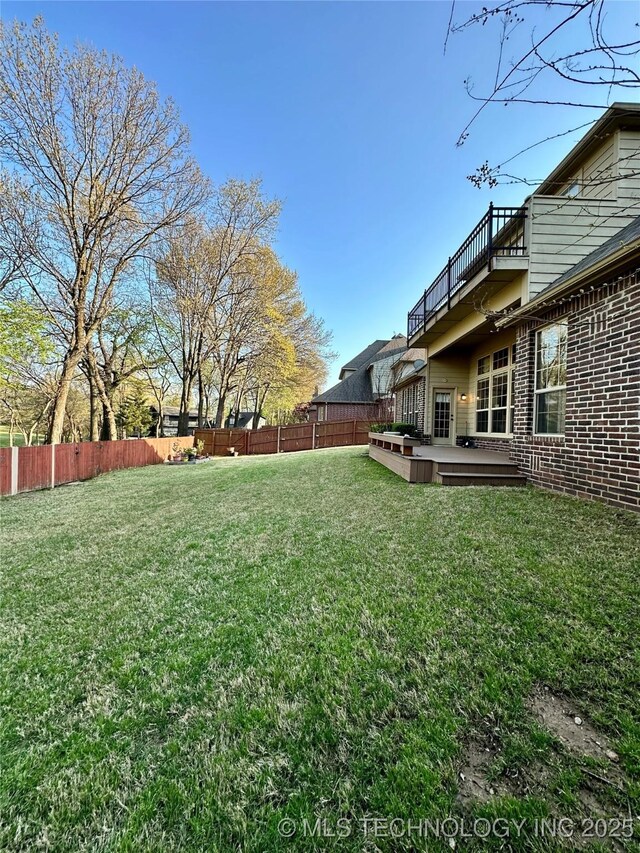 10213 S 88th E Ave, Tulsa, OK 74133 - fenced backyard with a wooden deck and a balcony