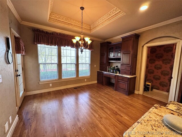 10213 S 88th E Ave, Tulsa, OK 74133 - kitchen with built in desk, wood finished floors, light countertops, glass insert cabinets, and crown molding