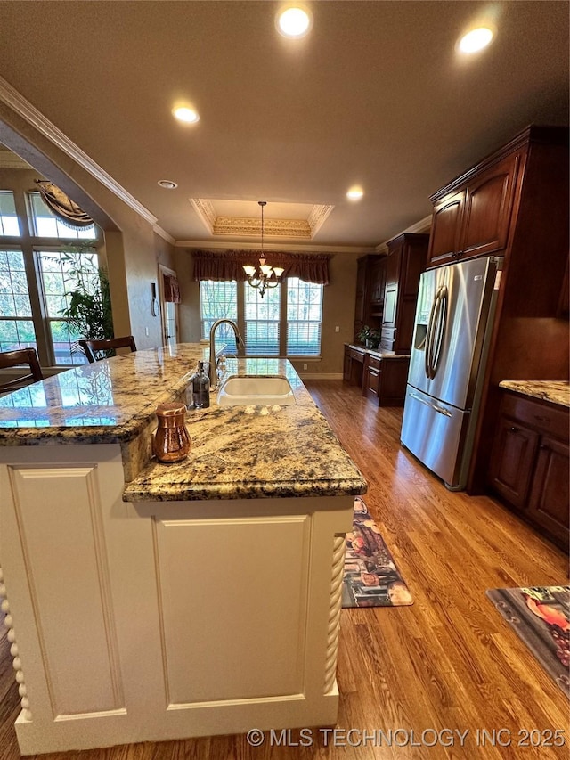 10213 S 88th E Ave, Tulsa, OK 74133 - kitchen with crown molding, stainless steel fridge with ice dispenser, a chandelier, a raised ceiling, and an island with sink