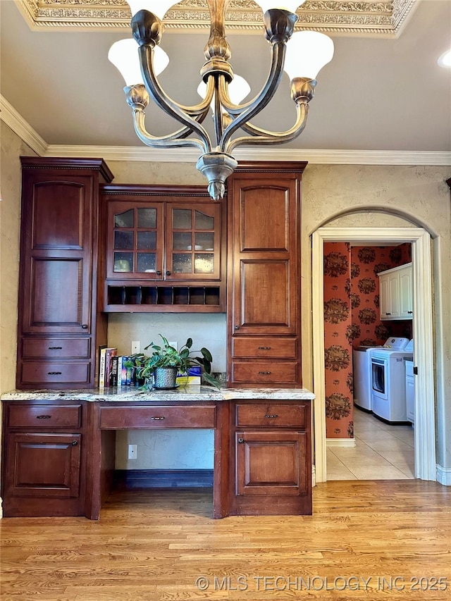10213 S 88th E Ave, Tulsa, OK 74133 - bar area featuring a chandelier, washer and dryer, light wood finished floors, built in desk, and crown molding