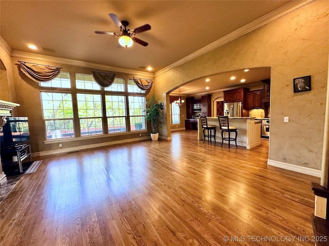 10213 S 88th E Ave, Tulsa, OK 74133 - living area with ornamental molding, ceiling fan, dark wood-style floors, arched walkways, and a textured wall