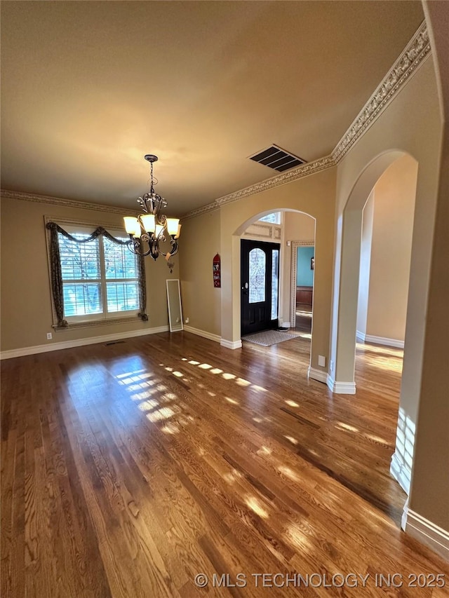 10213 S 88th E Ave, Tulsa, OK 74133 - unfurnished dining area featuring a chandelier, plenty of natural light, arched walkways, wood finished floors, and ornamental molding