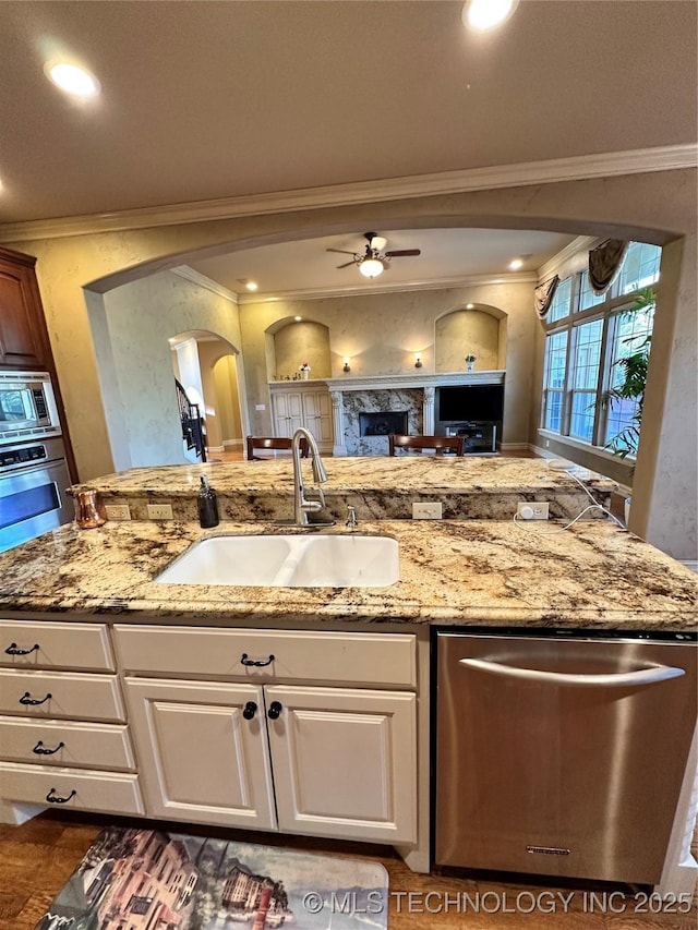 10213 S 88th E Ave, Tulsa, OK 74133 - kitchen featuring stainless steel appliances, crown molding, arched walkways, a ceiling fan, and open floor plan