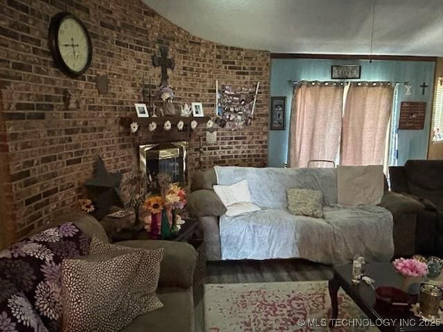 901 S Anthony St, Muskogee, OK 74403 - living room with brick wall, wood finished floors, and vaulted ceiling