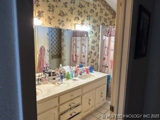 901 S Anthony St, Muskogee, OK 74403 - full bath with wallpapered walls, double vanity, and tile patterned floors