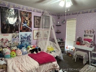 901 S Anthony St, Muskogee, OK 74403 - carpeted bedroom with a textured ceiling and ceiling fan