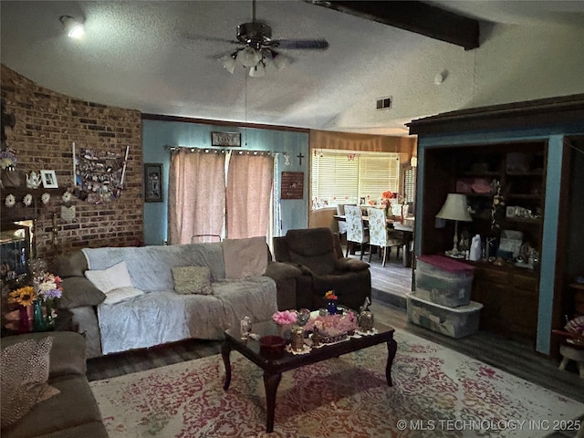 901 S Anthony St, Muskogee, OK 74403 - living area featuring vaulted ceiling, wood finished floors, ceiling fan, brick wall, and a textured ceiling