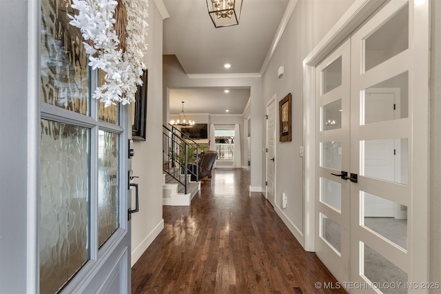 interior space with crown molding, stairs, a chandelier, and baseboards