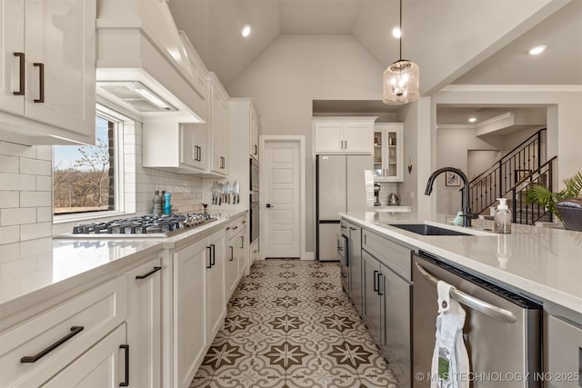 kitchen with stainless steel appliances, light countertops, and a sink