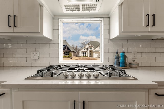 kitchen with visible vents, white cabinetry, and stainless steel gas cooktop
