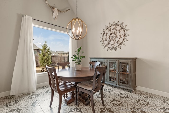 dining area with a chandelier and baseboards