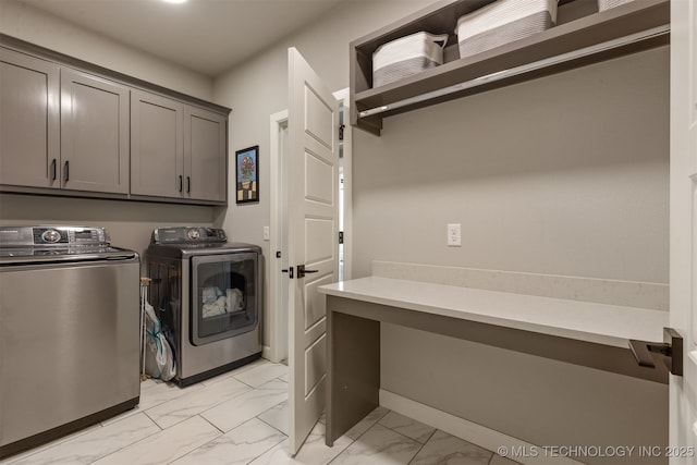 laundry room featuring baseboards, separate washer and dryer, cabinet space, and marble finish floor