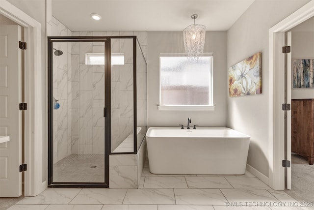 full bath featuring a marble finish shower, marble finish floor, a freestanding bath, and a wealth of natural light