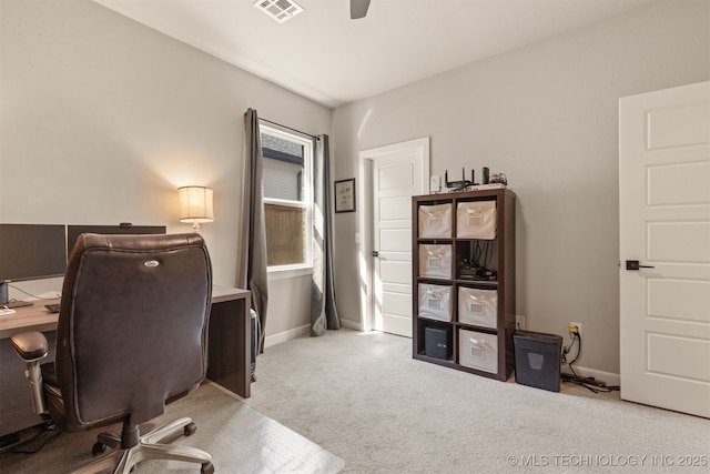 office space featuring carpet, visible vents, a ceiling fan, and baseboards