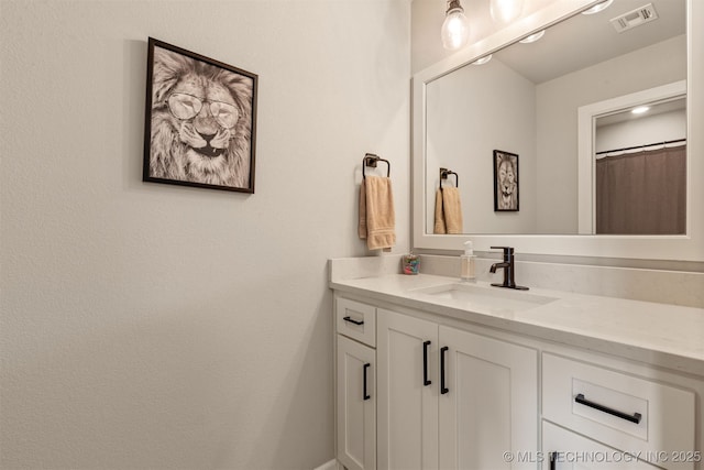 bathroom with visible vents and vanity