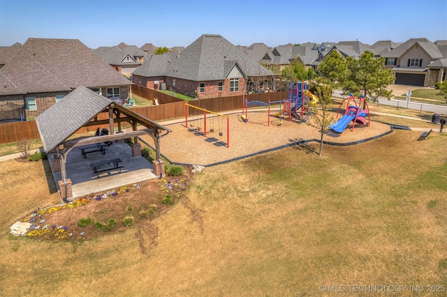 view of playground featuring a residential view, a gazebo, and fence