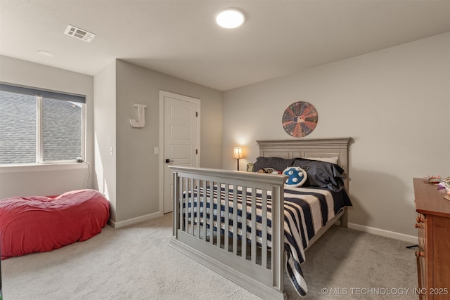 carpeted bedroom featuring baseboards and visible vents