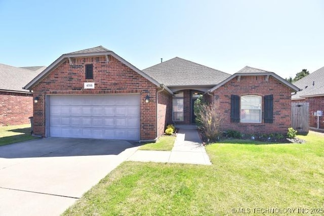 ranch-style house with a front yard, a garage, brick siding, driveway, and roof with shingles