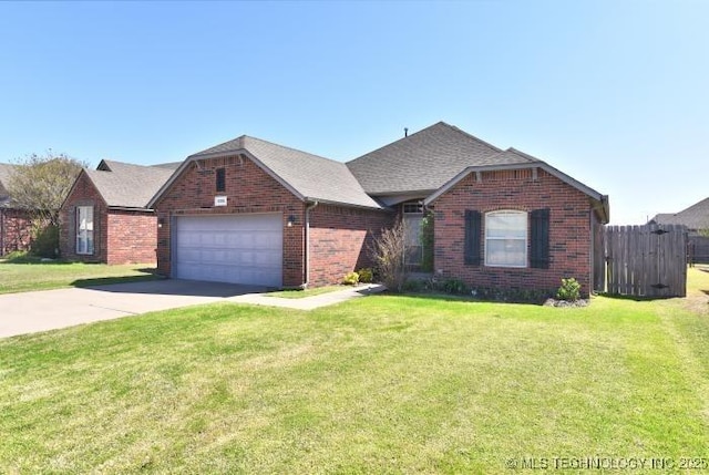 ranch-style house featuring an attached garage, concrete driveway, brick siding, a front lawn, and roof with shingles