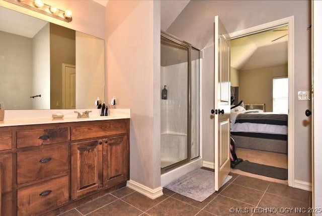 full bathroom featuring tile patterned floors, connected bathroom, a stall shower, and baseboards