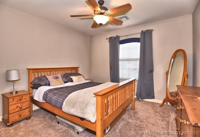 carpeted bedroom featuring ceiling fan, baseboards, and visible vents