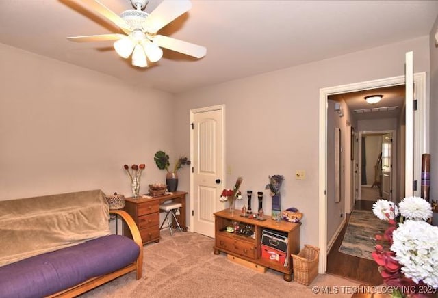 sitting room with carpet floors and ceiling fan
