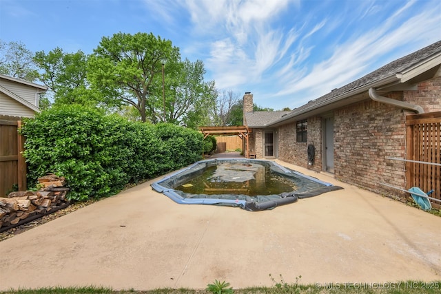 view of swimming pool with a patio area and fence