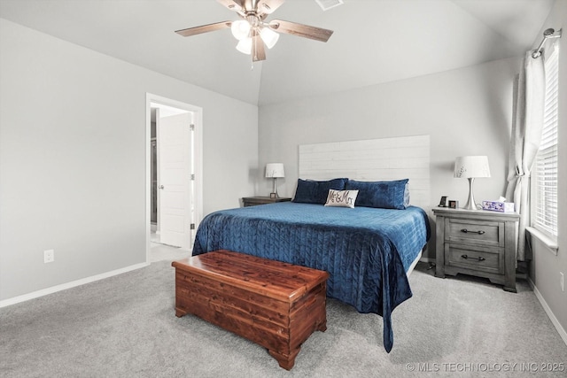 carpeted bedroom with ceiling fan, vaulted ceiling, multiple windows, and baseboards