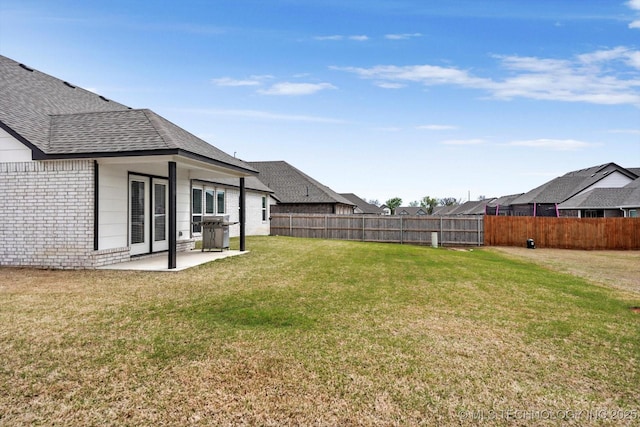 view of yard featuring fence and a patio