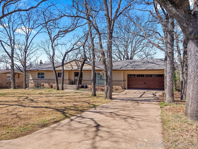 ranch-style house featuring a garage, stone siding, driveway, and a front lawn