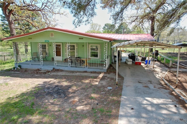 11847 Weaverville Ln, Kingston, OK 73439 - view of front of property featuring concrete driveway, a porch, metal roof, and a carport