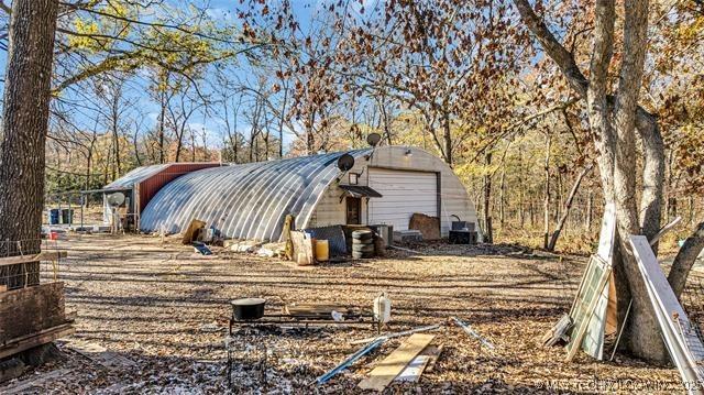 13760 SW Wilderness, Kingston, OK 73439 - view of yard featuring an outdoor structure, an outbuilding, and a detached garage
