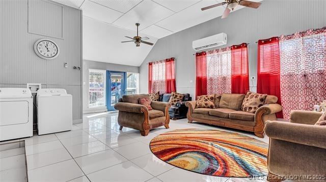 13760 SW Wilderness, Kingston, OK 73439 - living area featuring light tile patterned floors, an AC wall unit, a ceiling fan, independent washer and dryer, and vaulted ceiling