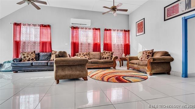 13760 SW Wilderness, Kingston, OK 73439 - living room with tile patterned floors, a wall unit AC, ceiling fan, and vaulted ceiling