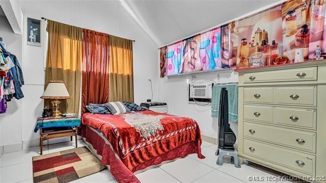 13760 SW Wilderness, Kingston, OK 73439 - bedroom featuring tile patterned floors, a wall mounted AC, and lofted ceiling