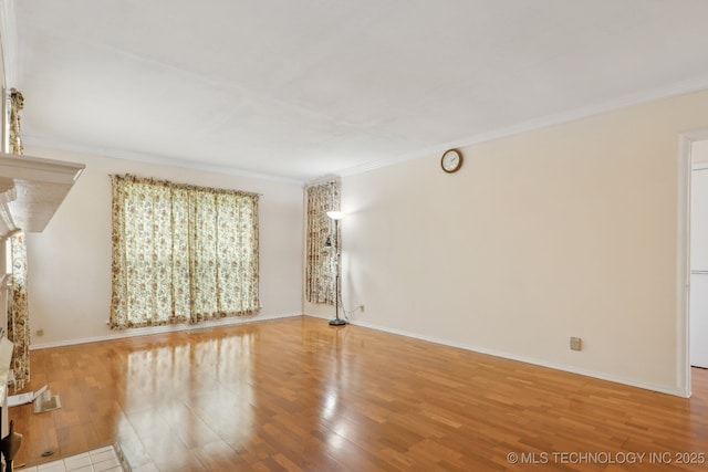 204 S Jamestown Ave, Tulsa, OK 74112 - unfurnished living room featuring ornamental molding, wood finished floors, and baseboards