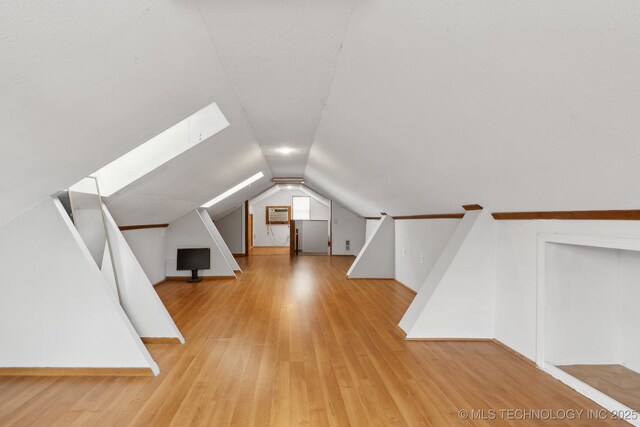 204 S Jamestown Ave, Tulsa, OK 74112 - bonus room featuring light wood-style floors, vaulted ceiling, and baseboards