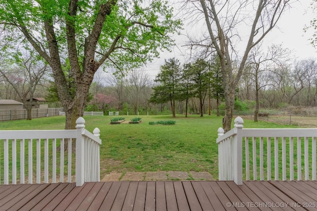 deck featuring a yard and fence