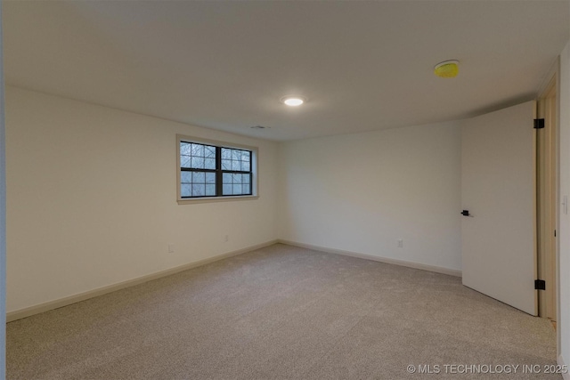 spare room with light carpet, visible vents, and baseboards