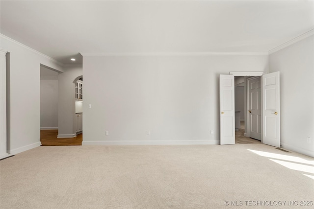 5815 S Knoxville Ave, Tulsa, OK 74135 - unfurnished bedroom featuring a spacious closet, carpet, baseboards, and ornamental molding