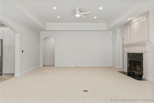 5815 S Knoxville Ave, Tulsa, OK 74135 - unfurnished living room with ornamental molding, ceiling fan, a raised ceiling, and arched walkways