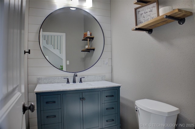 bathroom featuring toilet and vanity