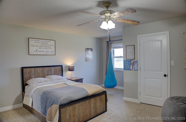 bedroom featuring baseboards, ceiling fan, and light colored carpet