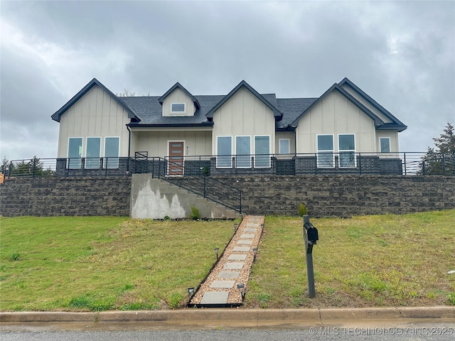 425 E 48th Ct, Sand Springs, OK 74063 - view of front of house with a front yard and board and batten siding