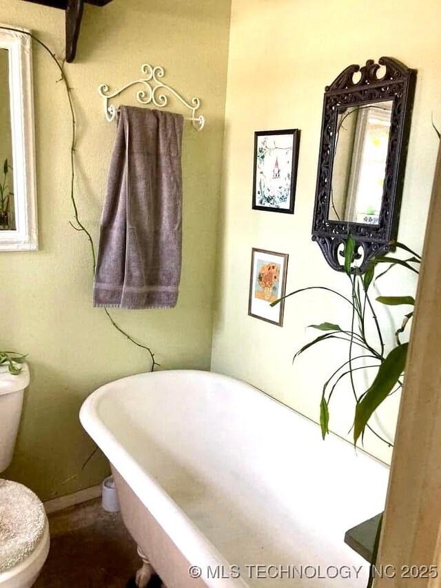 405 N Industrial Ave, Sand Springs, OK 74063 - bathroom featuring baseboards, a freestanding tub, and toilet