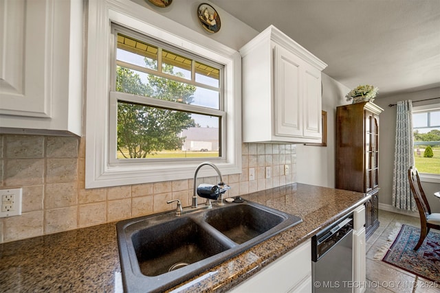 2003 Estates, Grove, OK 74344 - kitchen featuring tasteful backsplash, white cabinetry, dark stone counters, dishwasher, and a sink