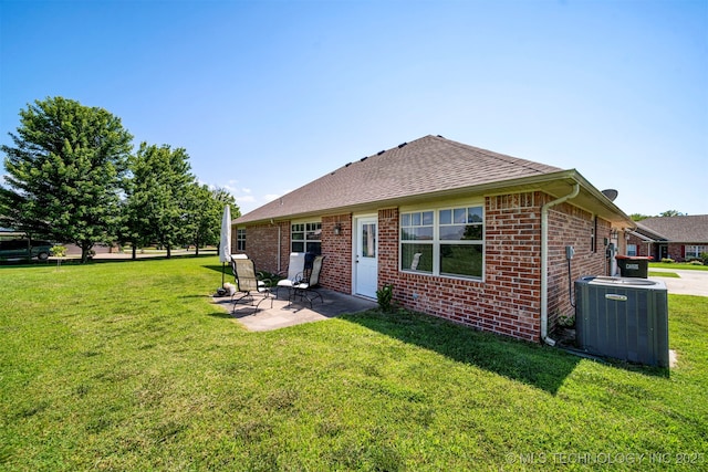 2003 Estates, Grove, OK 74344 - back of house with brick siding, cooling unit, a patio, and a lawn